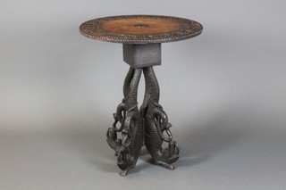 A circular 19th Century carved Anglo Indian hardwood occasional table with deep carving to the top, raised on 4 pierced and carved panel supports in the form of dragons 29"h x 24"diam. 