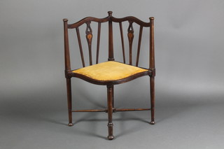 An Edwardian inlaid mahogany corner chair with X framed stretcher, raised on turned supports