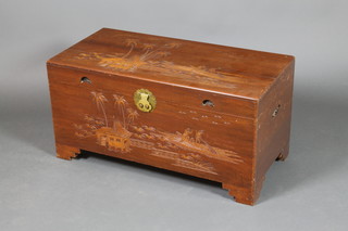 A carved camphor coffer with hinged lid, raised on bracket feet 18"h x 36"w x 18"d