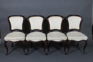 A set of 4 Victorian French mahogany show frame dining chairs with upholstered seats and backs, the seats of serpentine outline and raised on cabriole supports