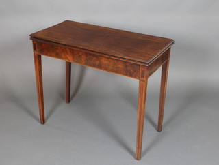 A Georgian rectangular inlaid mahogany tea table raised on square tapered legs 29"h x 35 1/2"w x 17 1/2"d