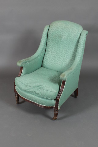A Victorian mahogany show frame armchair with upholstered seat and back on turned supports 