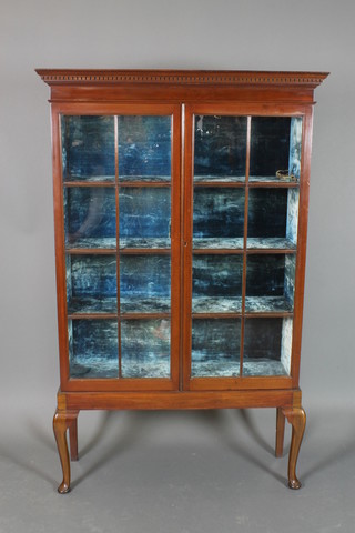 A 19th Century mahogany display cabinet with moulded and dentil cornice, the interior fitted plush lined shelves enclosed by astragal glazed panelled doors, raised on an associated base with cabriole supports 47 1/2"h x 42 1/2"w x 13"d