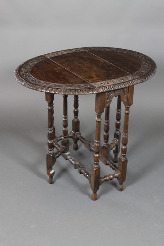 A Victorian carved oak oval drop flap gateleg tea table on turned and block supports 28"h x 25"w, when closed 10", when fully extended 33"