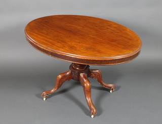 A Victorian mahogany oval snap top loo table raised on a turned column and tripod base 28"h x 45 1/2"w x 34 1/2"d