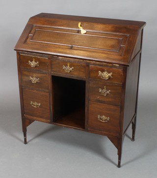 An Edwardian mahogany bureau, the fall front revealing a fitted interior above 1 short drawer and recess, flanked by 6 short drawers, raised on turned supports (formerly a bureau bookcase) 36"h x 31"w x 16"d 