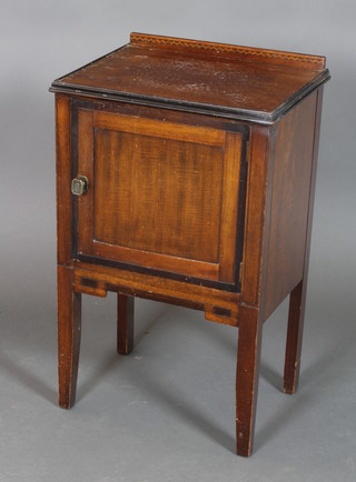 An Art Deco mahogany bedside cabinet with raised inlaid back, the cupboard enclosed by panelled doors on square tapered supports 31"h x 18"w x 14"d