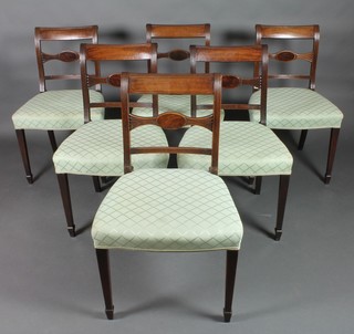 A set of 6 Georgian mahogany bar back dining chairs with shaped mid rails and over stuffed seats, raised on tapered legs, spade feet