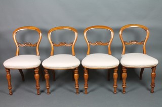 Ross of Dublin.  A set of 4 Victorian mahogany balloon back campaign chairs with shaped mid rails and upholstered seats (formerly caned) raised on turned supports, bases with metal plaques marked Ross & Co Manufacturers 9,10 & 11 Ellis Quay Dublin, one with worm to base