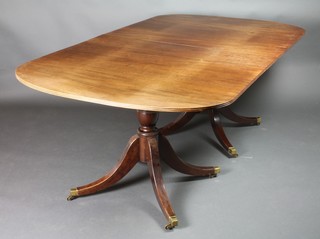 A Georgian style mahogany D end dining table with 1 extra leaf, raised on pillar and tripod supports ending in brass caps and castors 29"h x 78 1/2" when closed, 108 1/" with extra leaf x 44"d