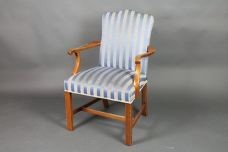 A Georgian style mahogany open arm library chair upholstered in blue striped material on square supports with H framed stretcher