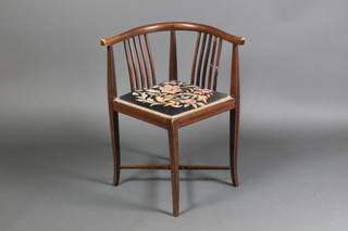 An Edwardian inlaid mahogany tub back corner chair raised on square tapering supports with H framed stretcher 