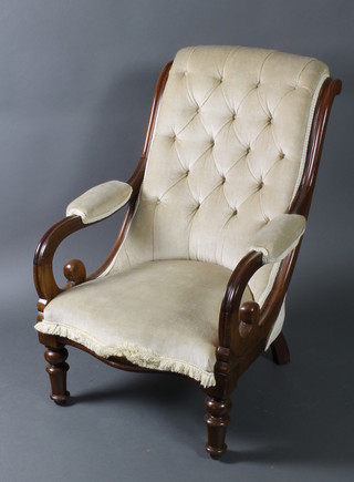 A Victorian mahogany show frame open arm chair, the seat and back upholstered in mushroom, raised on turned supports 