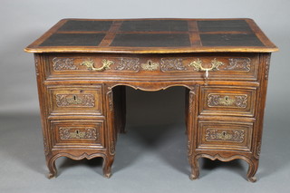 A French carved oak kneehole partners desk of serpentine outline, heavily carved throughout, fitted 1 long and 8 short drawers, raised on carved cabriole supports 31 1/2"h x 49"w x 31"d 