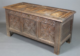 A 17th/18th Century carved oak coffer of panelled construction with hinged lid, the interior with replacement hinges and iron bracings to the corners 27"h x 54"w x 24 1/2"d 