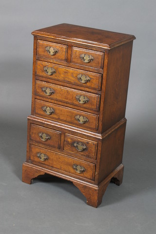 An 18th Century style oak chest on chest, the upper section fitted 2 short drawers above 3 long drawers, the base fitted 2 short drawers above 1 long drawer, raised on bracket feet, 32"h x 16"w x 11"d (in one section) 