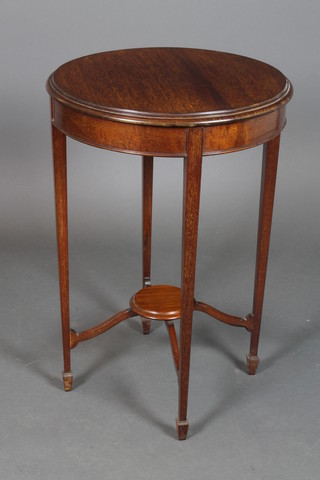 An Edwardian circular mahogany 2 tier occasional table raised on square tapering supports ending in spade feet, 29"h x 20" diam. 