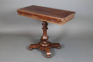 A Victorian bleached mahogany D shaped card table raised on a turned column and triform base 30"h x 36"w x 18"d