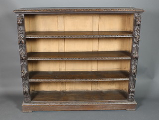 A Victorian carved oak bookcase, the interior fitted shelves, heavily carved throughout, raised on a platform base 48"h x 54"w x 13 1/2"d 
