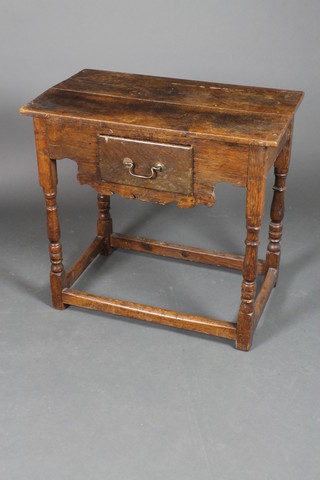 An 18th Century oak side table fitted a drawer, raised on turned and block supports with box stretcher 29"h x 31"w x 18"d