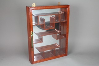 A Chinese rosewood hanging display cabinet with mirrored panel, fitted shelves enclosed by a glazed panelled door 20"h x 15"w x 3"d