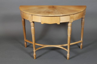 George Finch, a Georgian style bleached walnut demi-lune table, fitted a drawer and raised on turned and fluted supports with shaped stretcher, the interior with silver label marked made from a walnut tree felled at Wildacres Farningham Kent 1961 27"h x 39"w x 20"d  
