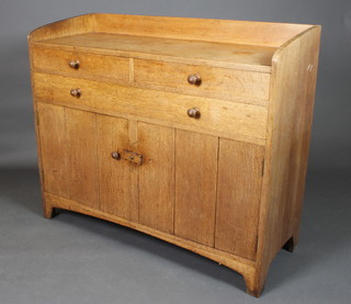 Heal's, an Edwardian Art Nouveau light oak sideboard with three-quarter gallery above 2 long and 1 long drawer, the base fitted a cupboard enclosed by panelled doors with tore handles (1 handle missing) 40"h x 40"w x 18"d 