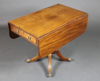 A Georgian mahogany pedestal Pembroke table fitted a drawer, raised on a turned column with tripod supports and brass caps and casters 28"h x 19" when closed x 39" when open, x 34"w 
