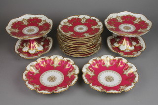 A French red and gilt dessert service comprising 2 tazza, 2 bowls, 2 shaped dishes and 11 plates
