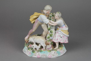 A 19th Century German group of a shepherd and shepherdess on a raised Rococo base 8" (f)