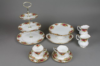 A Royal Albert Old Country Rose tea set comprising 12 tea cups, 12 saucers, 12 tea plates, sugar bowl, 2 milk jugs, cake plate, 3 tier cake stand, a tazza