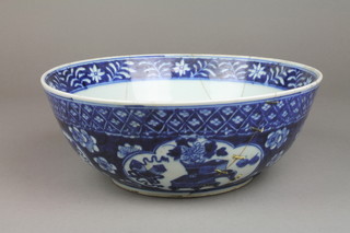 A 19th Century Chinese blue and white bowl decorated with panels of flowers, 4 character mark to base 11" (f)
