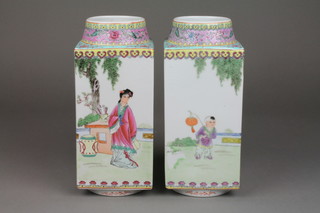 A pair of 20th Century squared famille rose vases with waisted necks decorated with figures in pavillion gardens and script, with red seal mark to the base 9" 