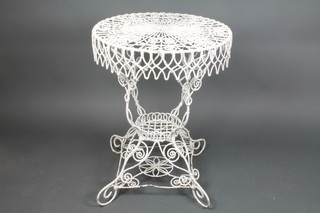 A Victorian circular white painted pierced wire work 2 tier garden occasional table, raised on scroll supports 35"h x 23 1/2"d