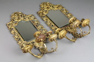 A pair of Victorian arch shaped pierced gilt metal 3 light wall sconces the backs fitted an arched bevelled plate mirror 21" x 10"