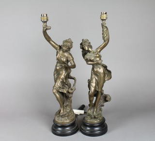 A pair of resin table lamps in the form of standing girls with torches 21 1/2" 