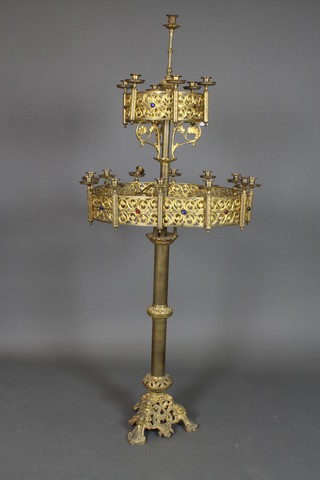 A Victorian Gothic pierced and gilt metal 2 tier 19 light floor standing candelabrum inset cabouchon cut stones, raised on pierced triform supports, 1 sconce f, 67"h x 24" diam. 