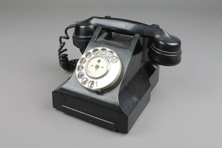 A black Bakelite dial telephone, the base marked 232F