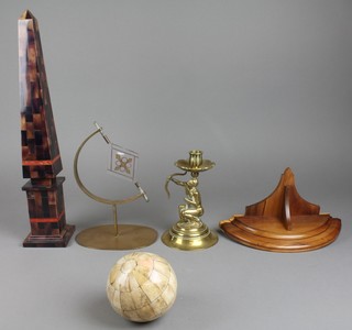 A demi-lune yew wall bracket 10", an obelisk, a brass candlestick decorated a figure of a bowman 7", a horn globe and a brass and glass armillary 