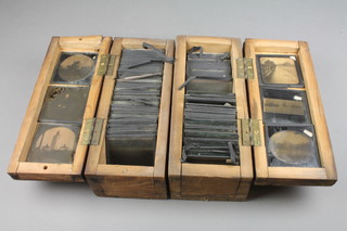 2 shallow boxes with hinged lids containing a collection of various glass slides 