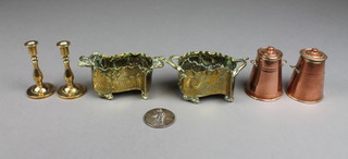 A pair of brass Art Nouveau shaped twin handled dishes, raised on panel supports 3", a pair of waisted copper churns 2", a pair of brass candlesticks marked Peerage and a commemorative medal 3" 