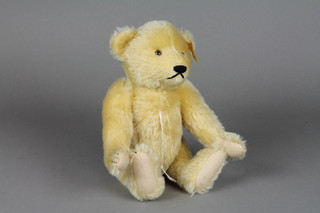 A yellow Steiff teddybear with articulated limbs 10" 
