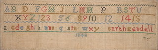 A rectangular Victorian woolwork sampler with alphabet and numerals 1848 4 1/2" x 12 1/2"
