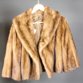 A lady's mink shoulder length jacket together with a white fur stole 