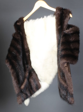 A brown fur jacket together with a white fur stole