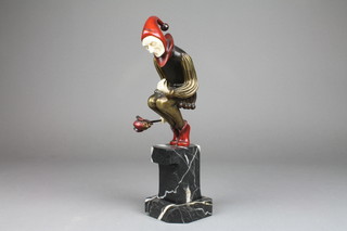 Roland Paris, an Art Deco style bronze figure of a seated jester, raised on a black and white stepped marble base 12"