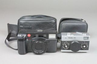 A Leica camera AF-C1 1:2.8/40 1:5.6/80 together with a Roley 35 camera 