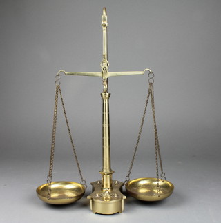 A pair of brass scales complete with weights 