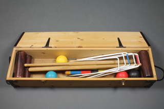 A Townsend croquet set comprising 4 mallets, 4 balls, 6 hoops complete with pine carrying case 