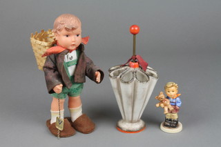 A Goebels vase in the form of an umbrella VX60 7", a Hummel figure Christmas gift 3 1/2" and a Hummel rubber figure 8"